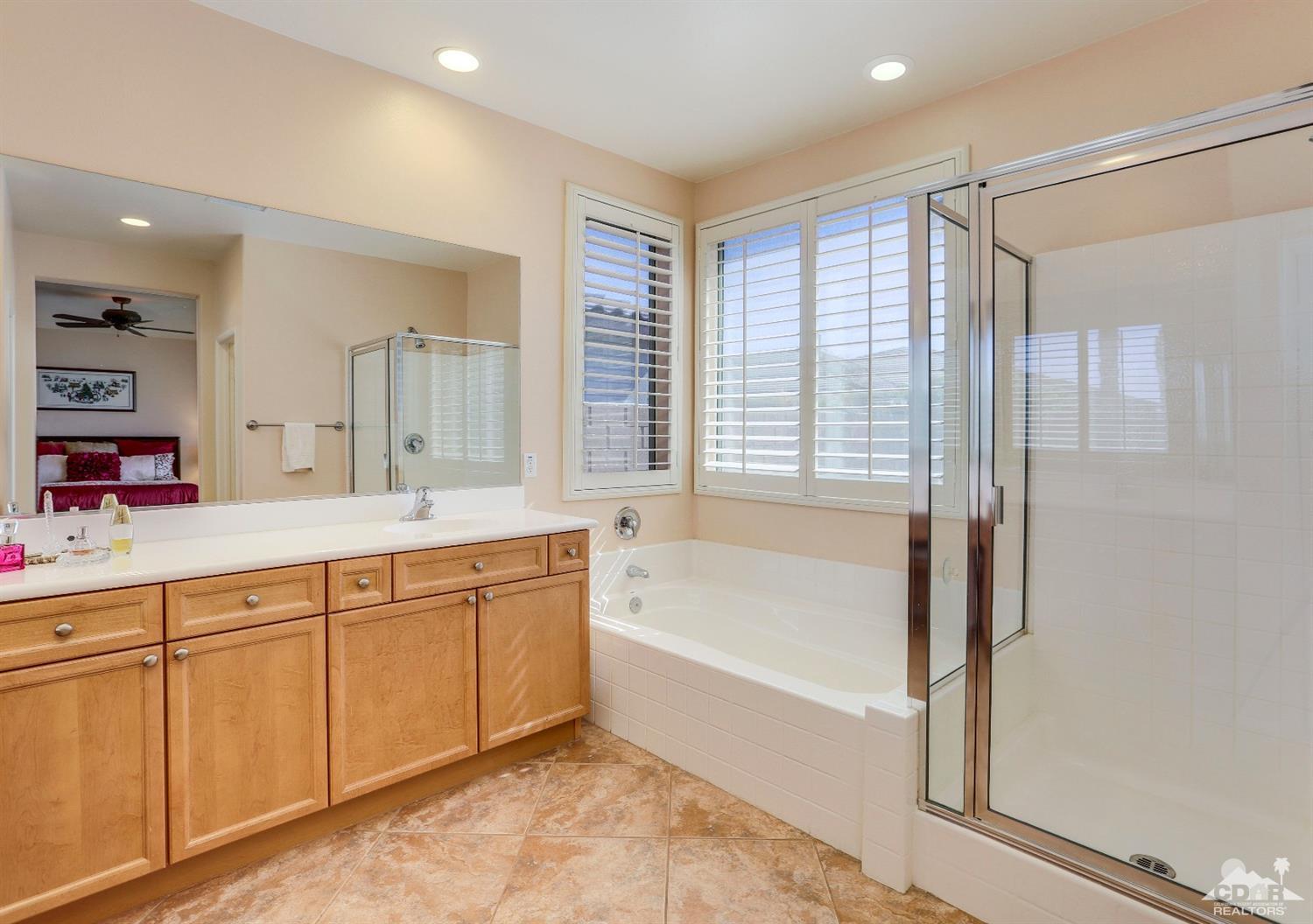 83313 Lone Star Road Indio, CA 92203 - Photo 12 of 23 a spacious bathroom with a tub sink shower and mirror