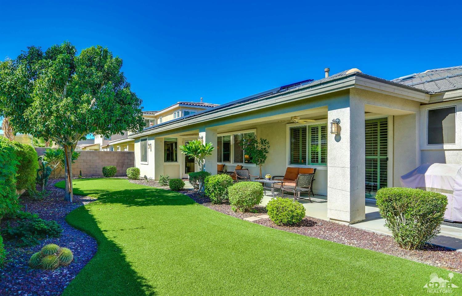 83313 Lone Star Road Indio, CA 92203 - Photo 3 of 23 a view of a house with backyard sitting area and garden