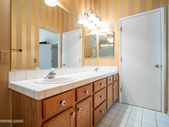 a view of a porch with chairs and potted plants