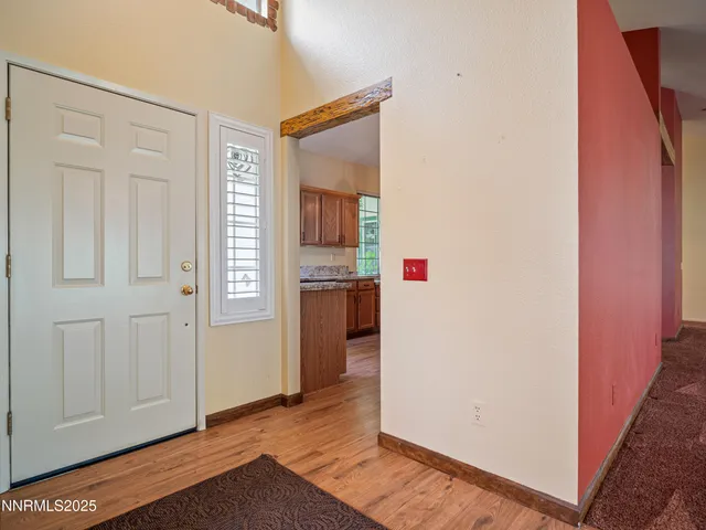 a view of an empty room with a fireplace and a window