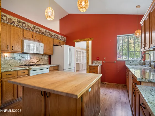 a kitchen with a stove a sink dishwasher and a refrigerator