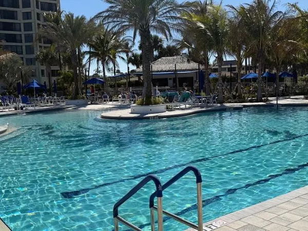 a view of a swimming pool with a table and chairs