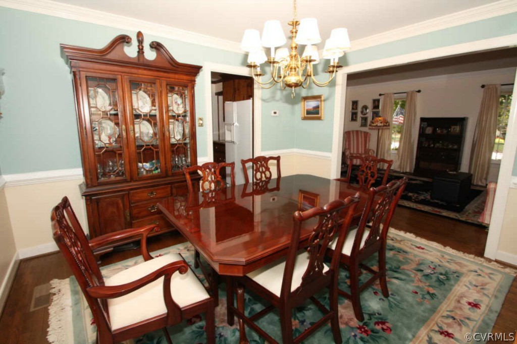 2141 Corner Rock Road Midlothian, VA 23113 - Photo 9 of 22 a dining room with furniture a chandelier and wooden floor