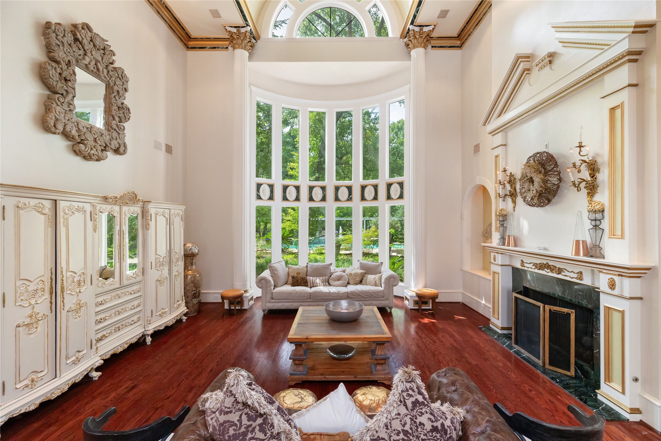 205 Grogans Point Road The Woodlands, TX 77380 - Photo 12 of 49 a living room with furniture a fireplace and a floor to ceiling window