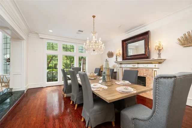 a living room with fireplace furniture and a large window