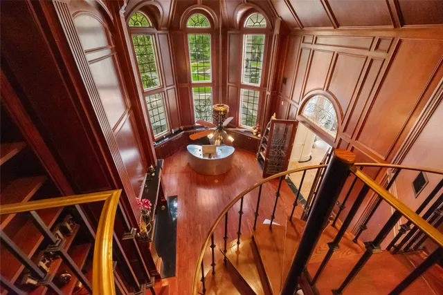a living room with furniture a flat screen tv and a floor to ceiling window