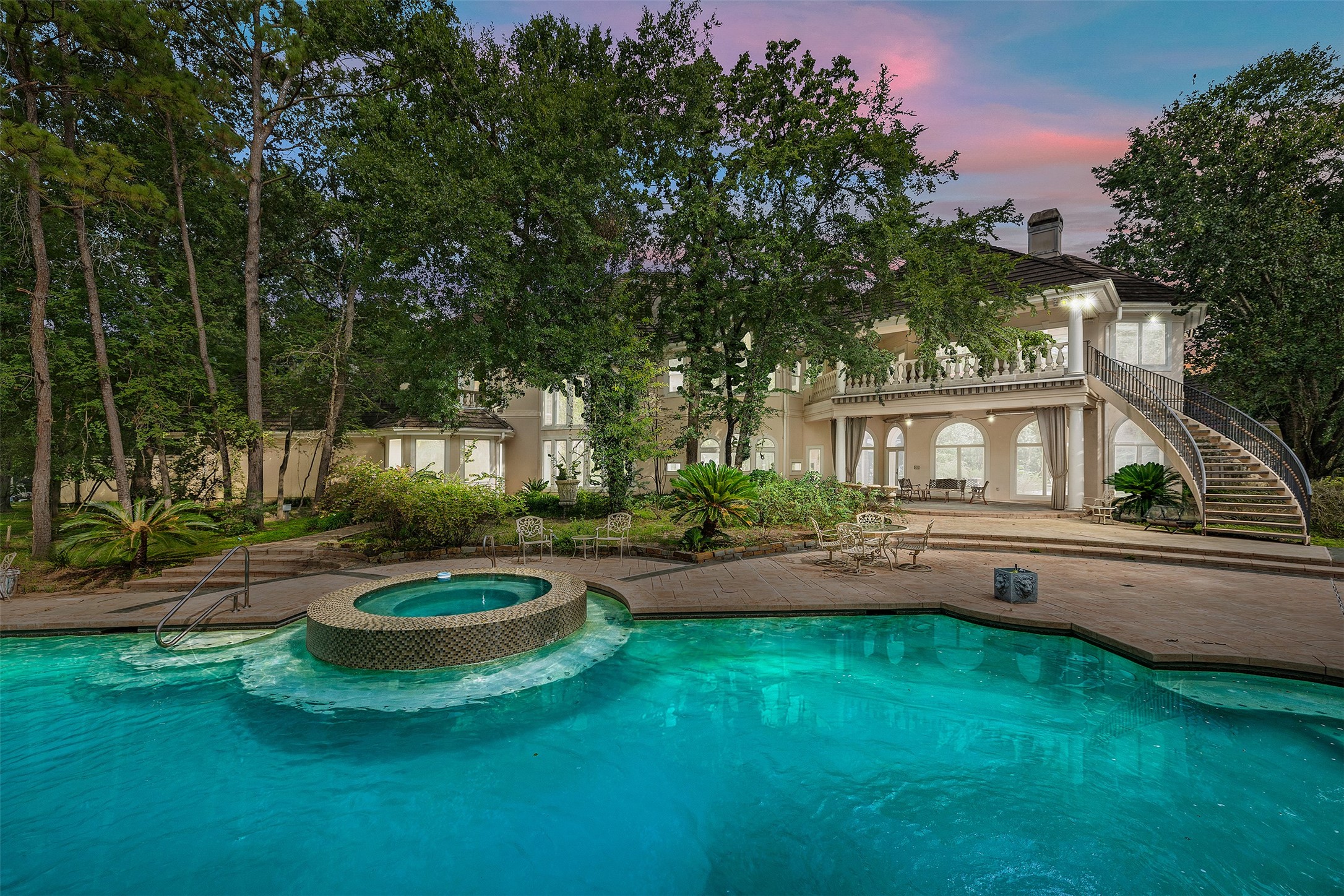 205 Grogans Point Road The Woodlands, TX 77380 - Photo 2 of 49 a front view of a house with swimming pool having outdoor seating