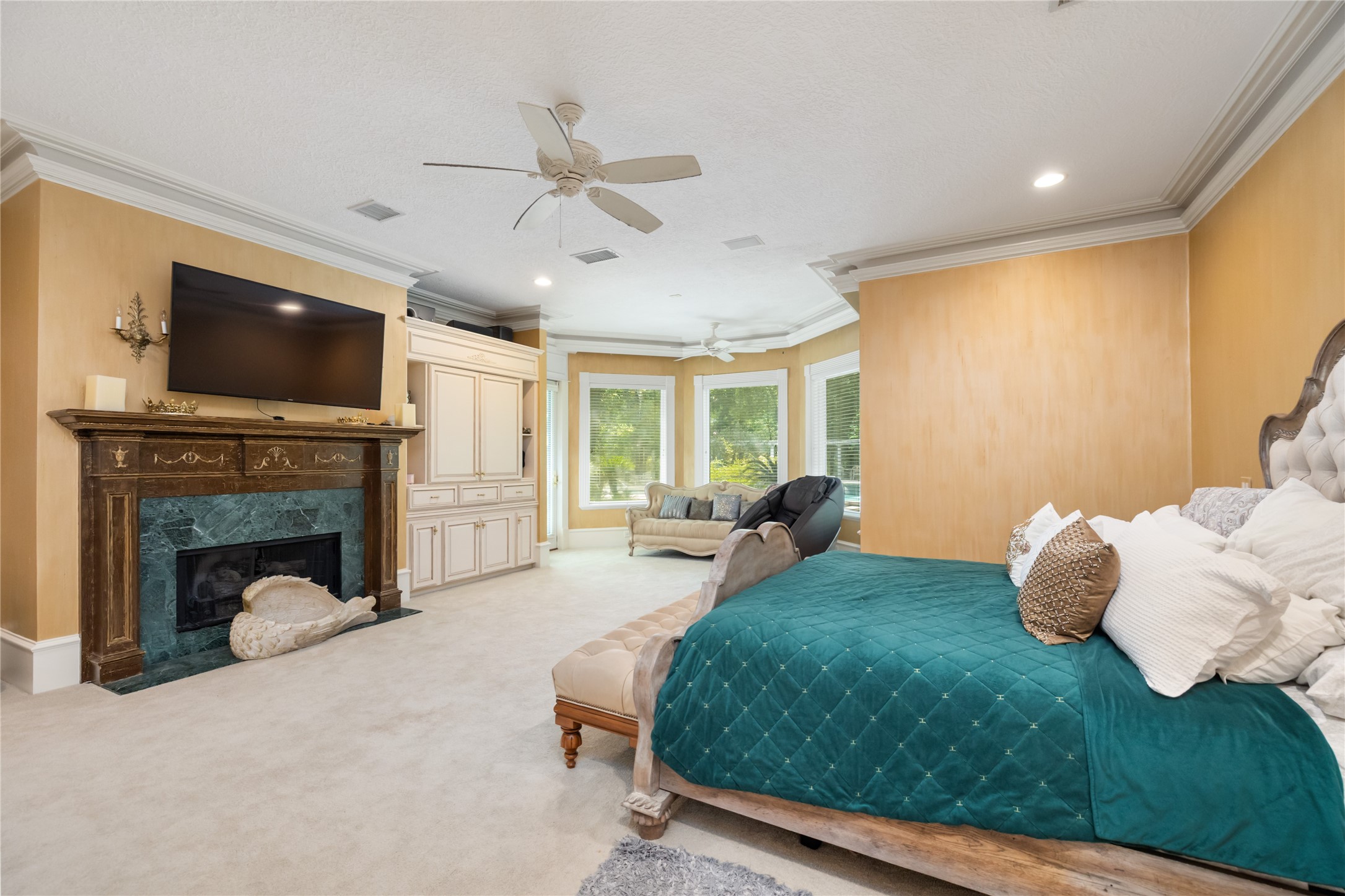 205 Grogans Point Road The Woodlands, TX 77380 - Photo 21 of 49 a bed room with a bed and a fireplace