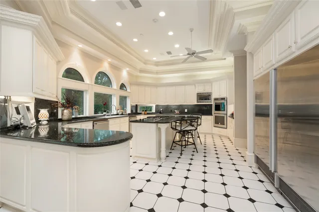 a kitchen with stainless steel appliances granite countertop a sink and cabinets