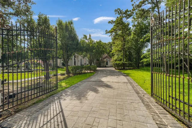 a view of a park with iron fence