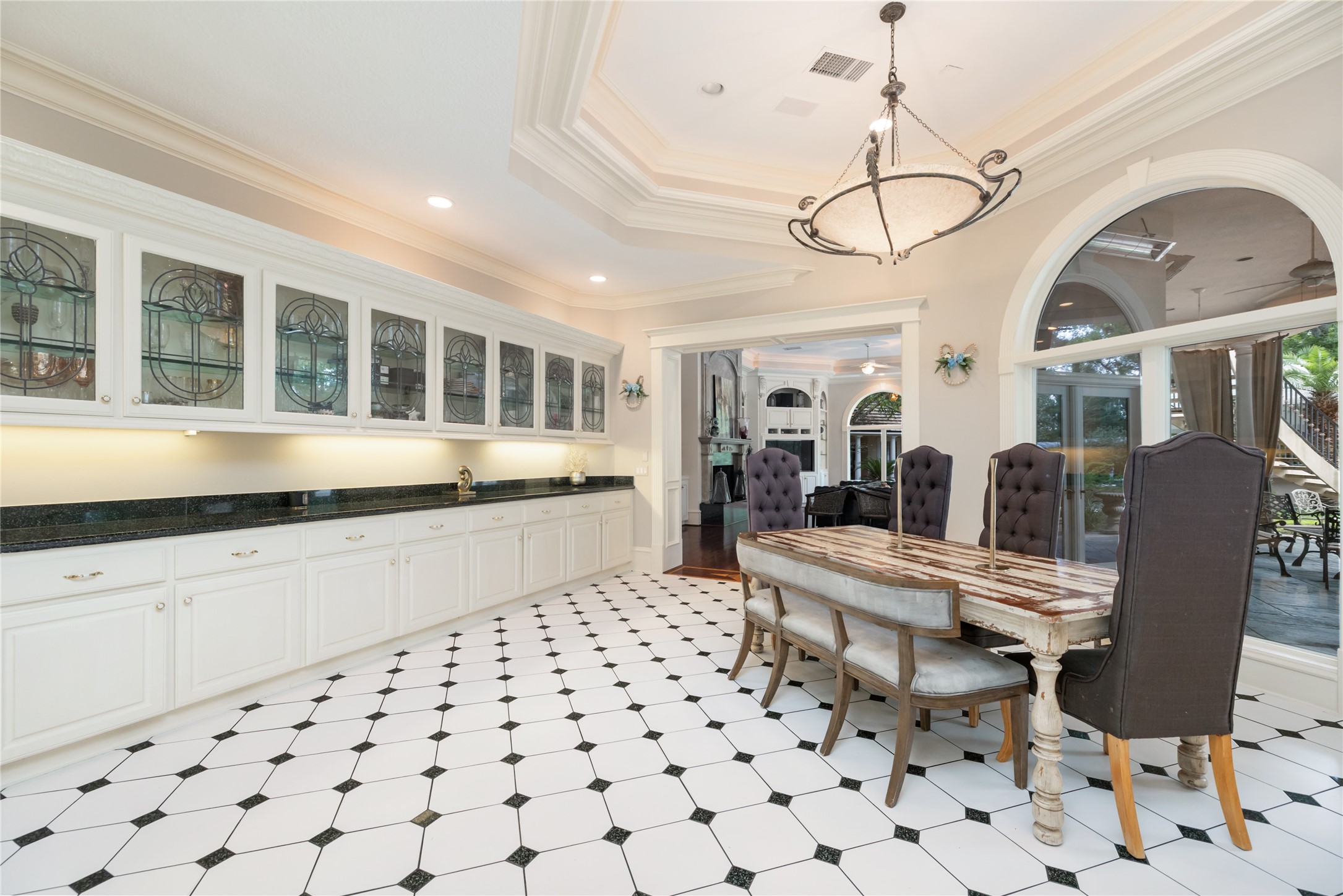 205 Grogans Point Road The Woodlands, TX 77380 - Photo 31 of 49 a large white kitchen with a large window and cabinets