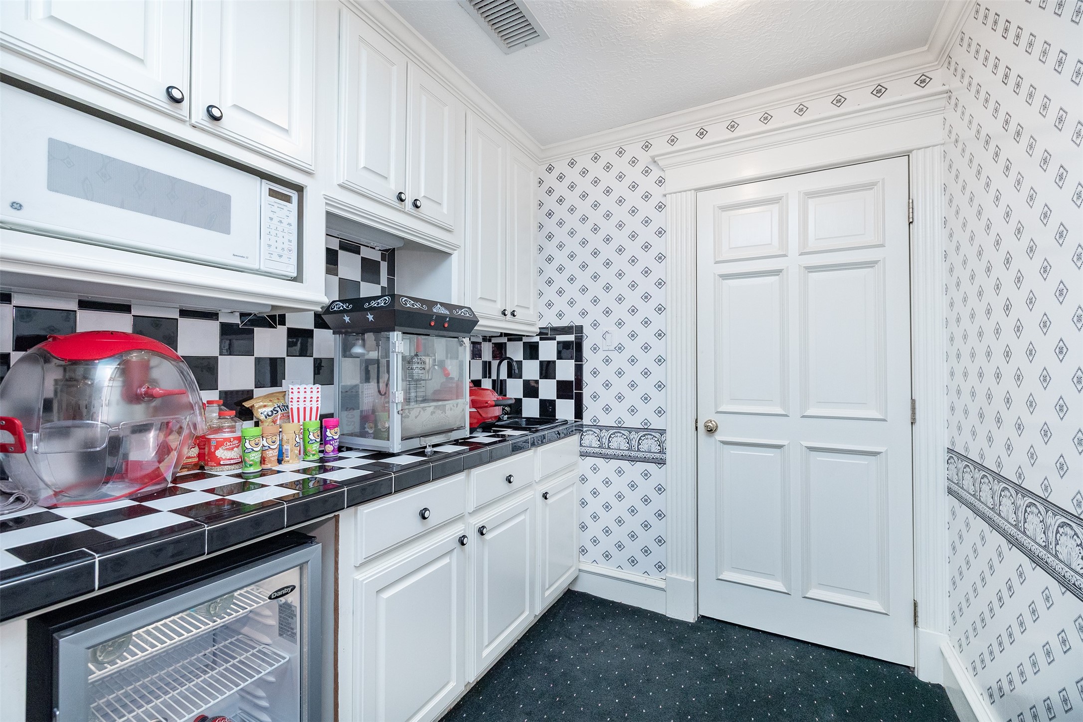 205 Grogans Point Road The Woodlands, TX 77380 - Photo 33 of 49 a kitchen with stainless steel appliances granite countertop a sink and cabinets