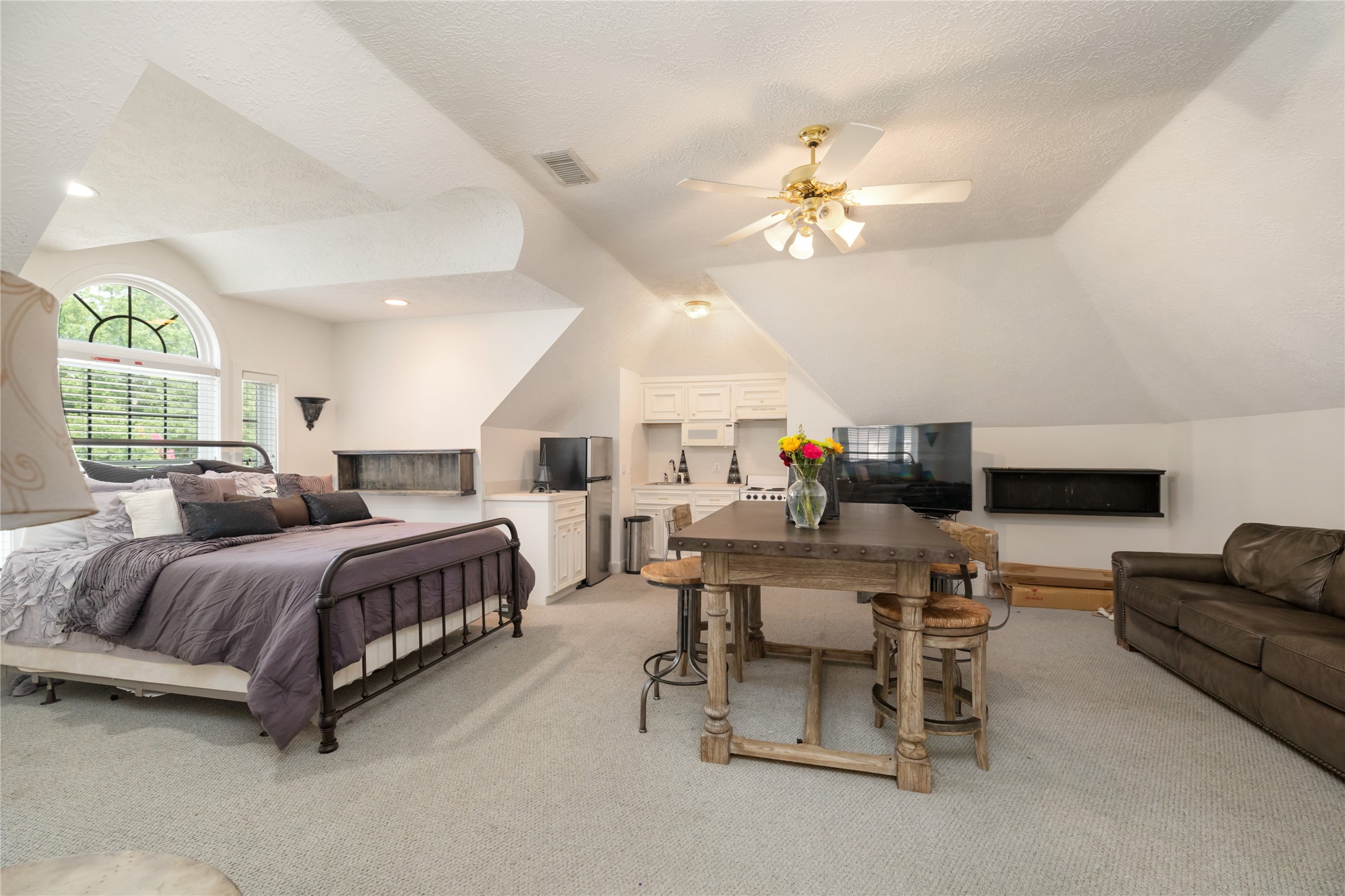 205 Grogans Point Road The Woodlands, TX 77380 - Photo 35 of 49 a bedroom with a bed gym equipment and a chandelier