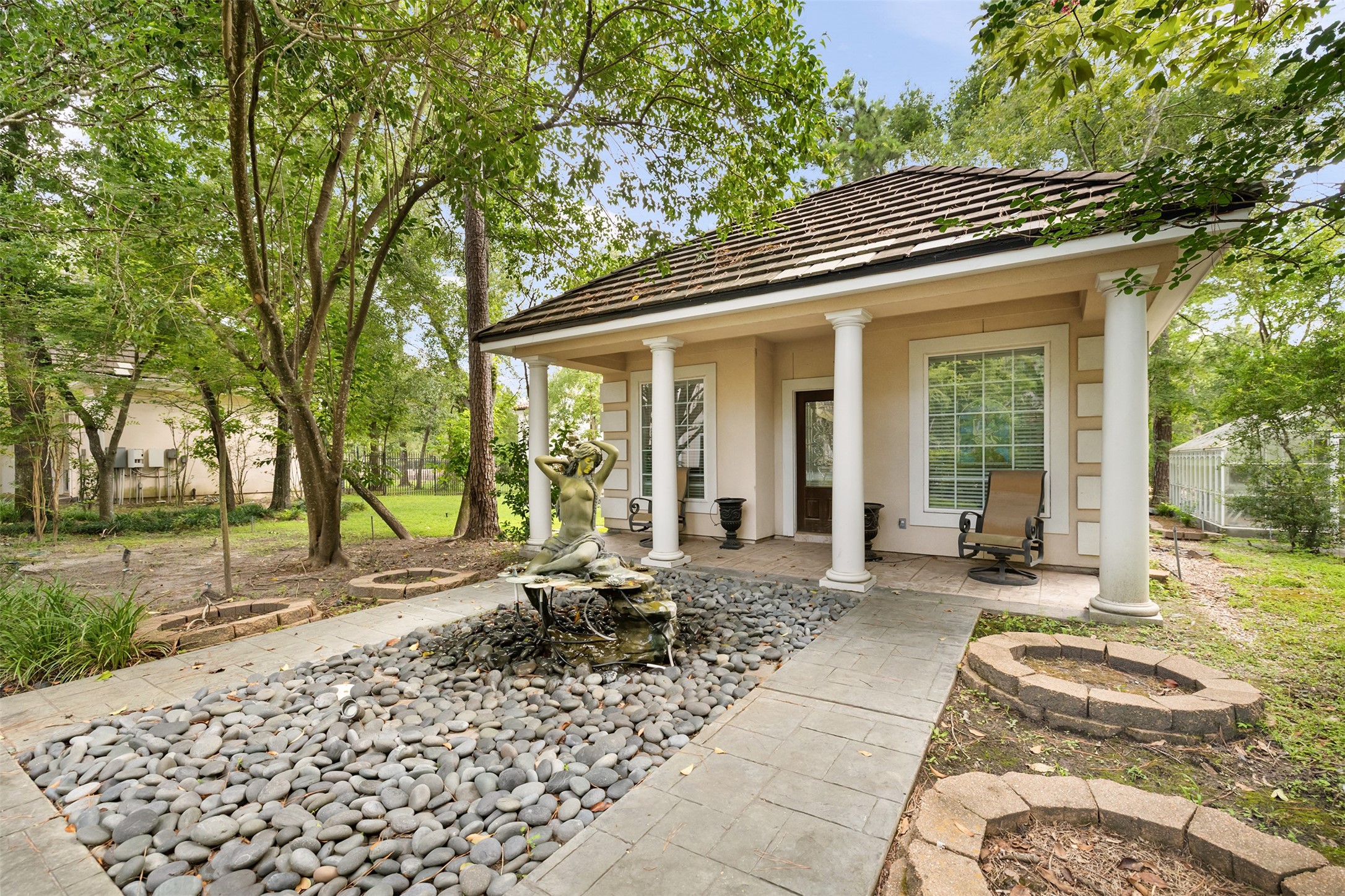 205 Grogans Point Road The Woodlands, TX 77380 - Photo 38 of 49 a view of a house with backyard sitting area and garden
