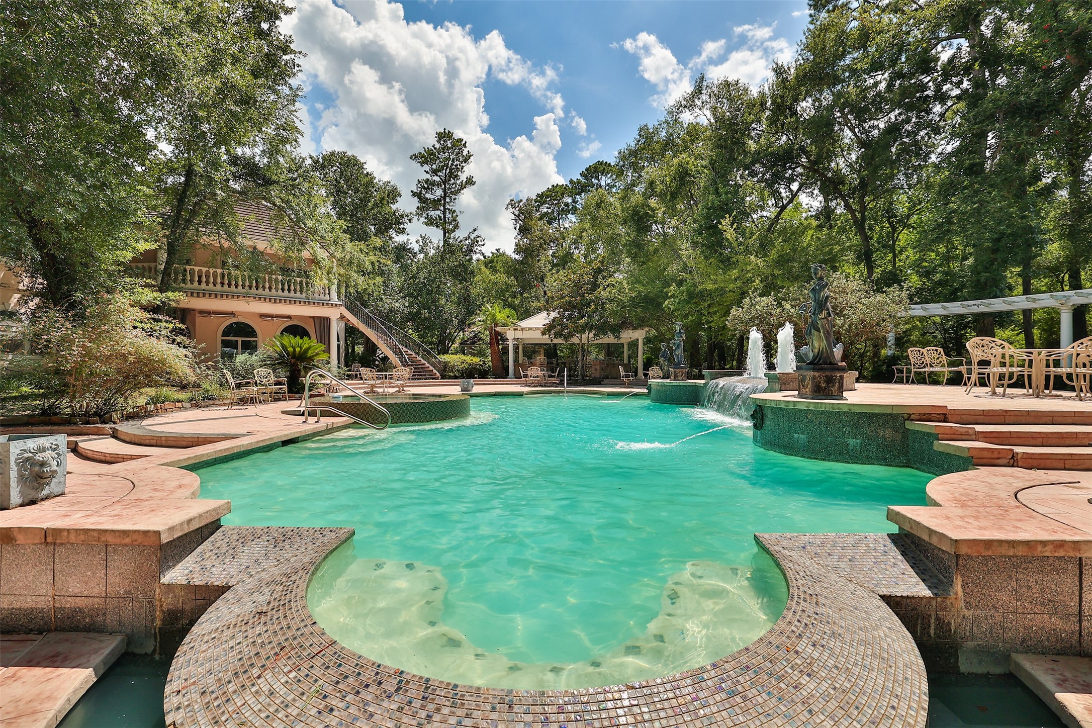 205 Grogans Point Road The Woodlands, TX 77380 - Photo 44 of 49 a view of a house with a backyard porch and sitting area