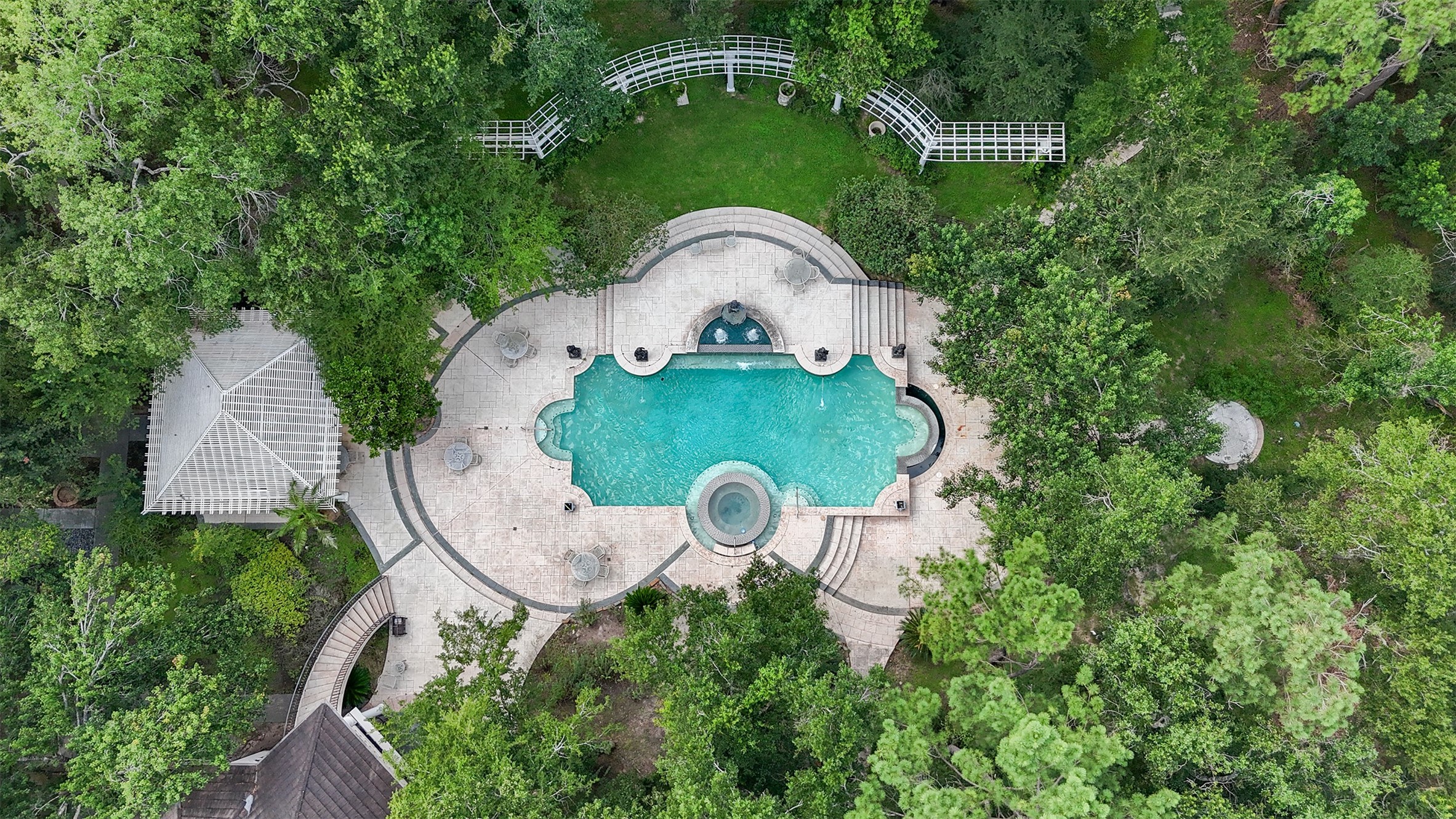 205 Grogans Point Road The Woodlands, TX 77380 - Photo 48 of 49 an aerial view of a house with garden space and outdoor seating