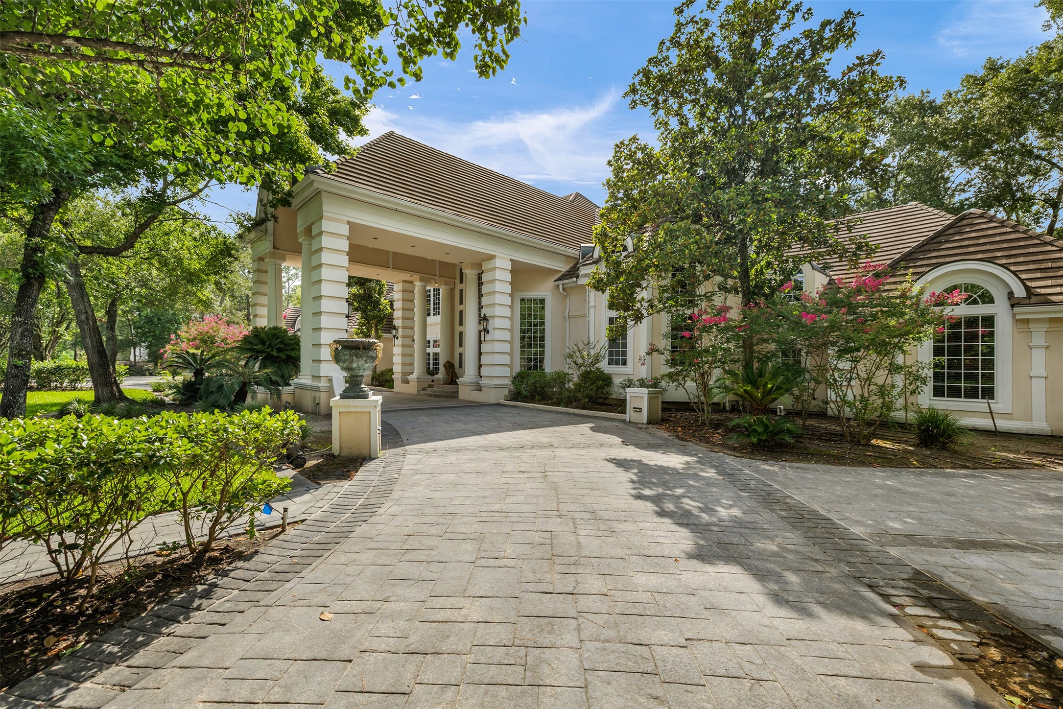 205 Grogans Point Road The Woodlands, TX 77380 - Photo 5 of 49 a view of a house with potted plants and a pathway