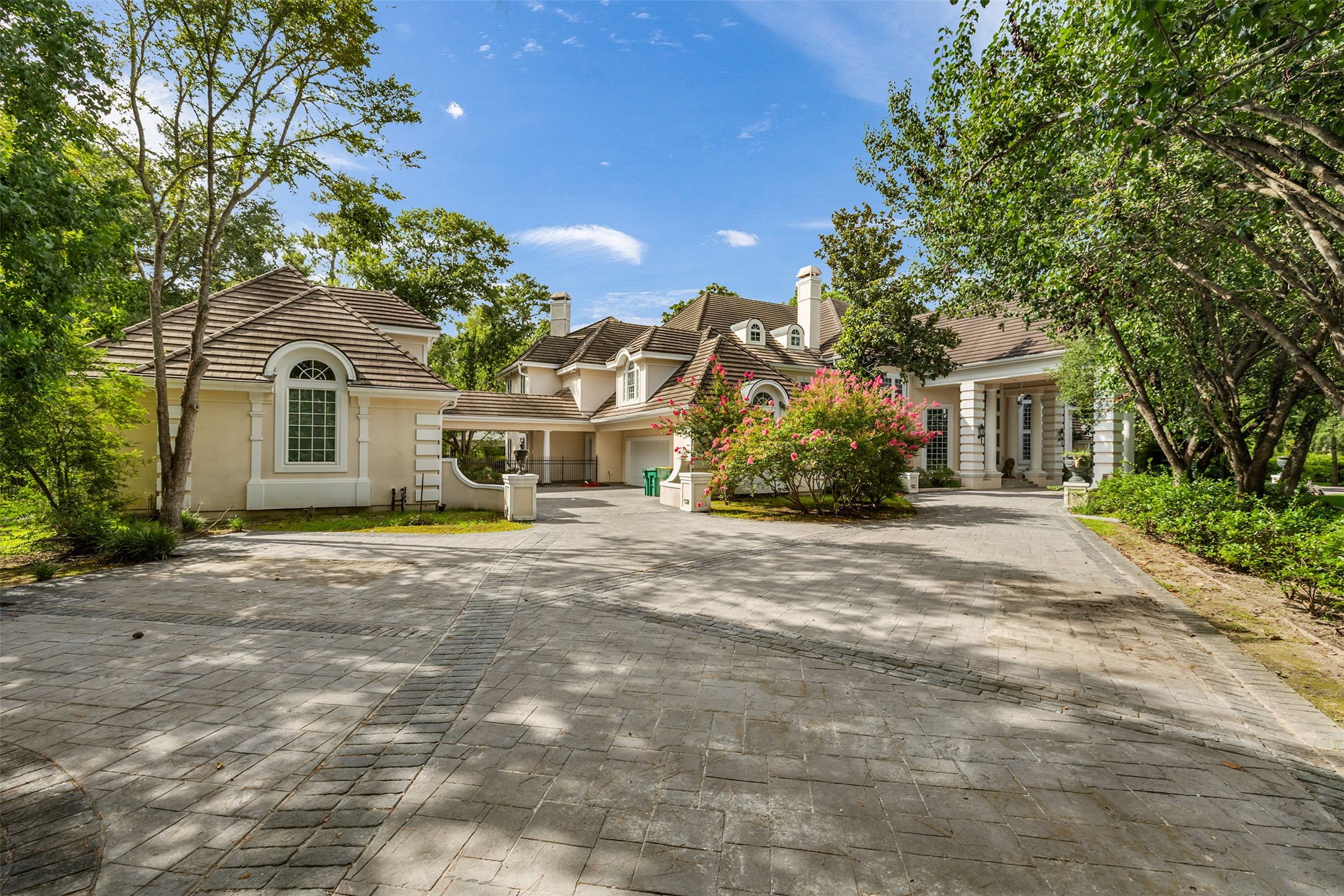 205 Grogans Point Road The Woodlands, TX 77380 - Photo 6 of 49 a front view of a house with a garden