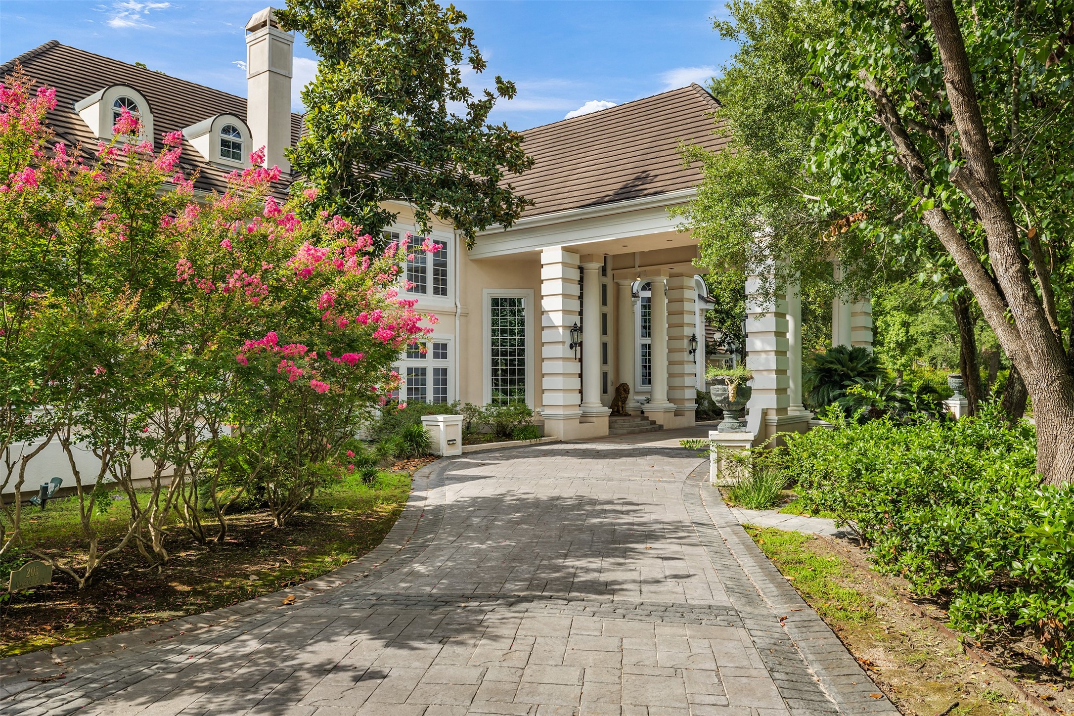 205 Grogans Point Road The Woodlands, TX 77380 - Photo 9 of 49 a view of a house with flower plants