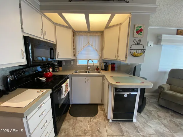 a kitchen with a stove a sink and a microwave