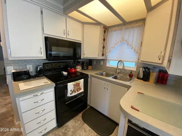 a kitchen with stainless steel appliances a stove a sink and a microwave