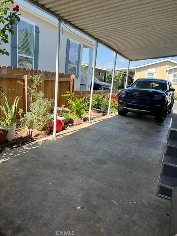 a view of a house with a car parked beside a road