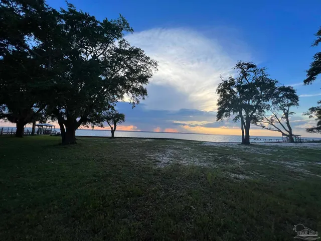a view of outdoor space with green field and trees