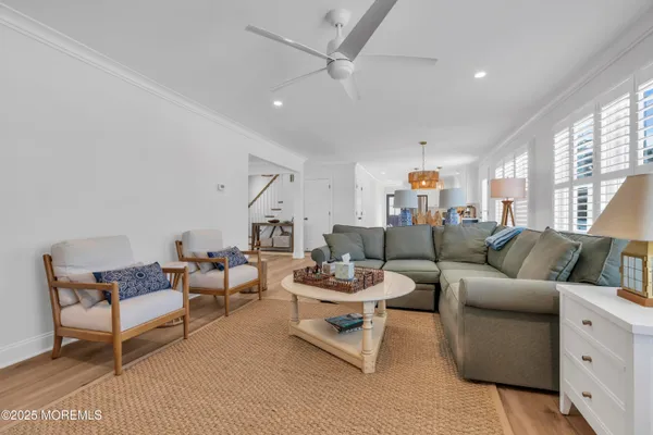 a living room with furniture and a ceiling fan