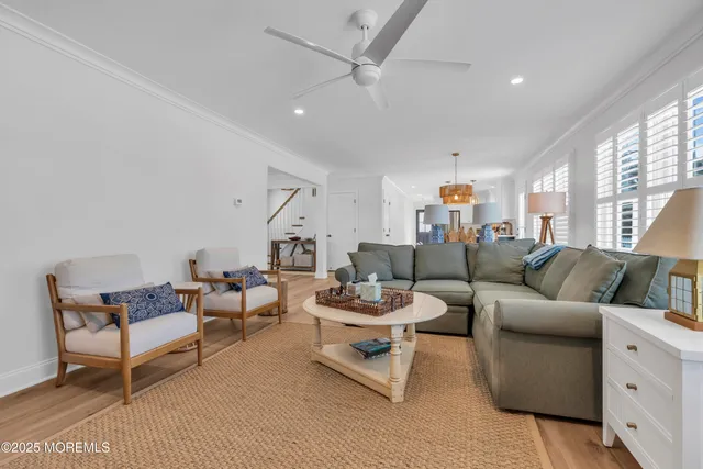 a living room with furniture and a ceiling fan