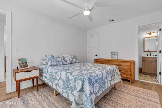 a bedroom with a bed and a view of kitchen