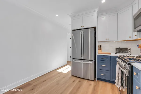 a kitchen with stainless steel appliances granite countertop a refrigerator and a stove top oven