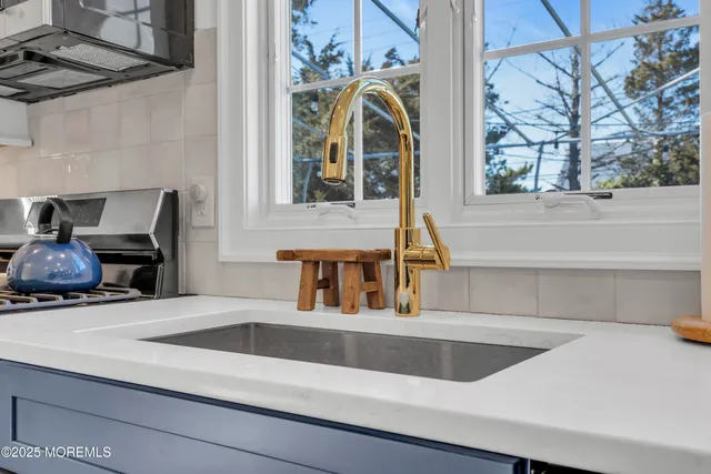 a view of a kitchen sink and a window