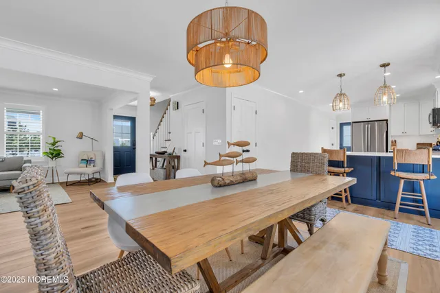 a living room with dining table and a wooden floor
