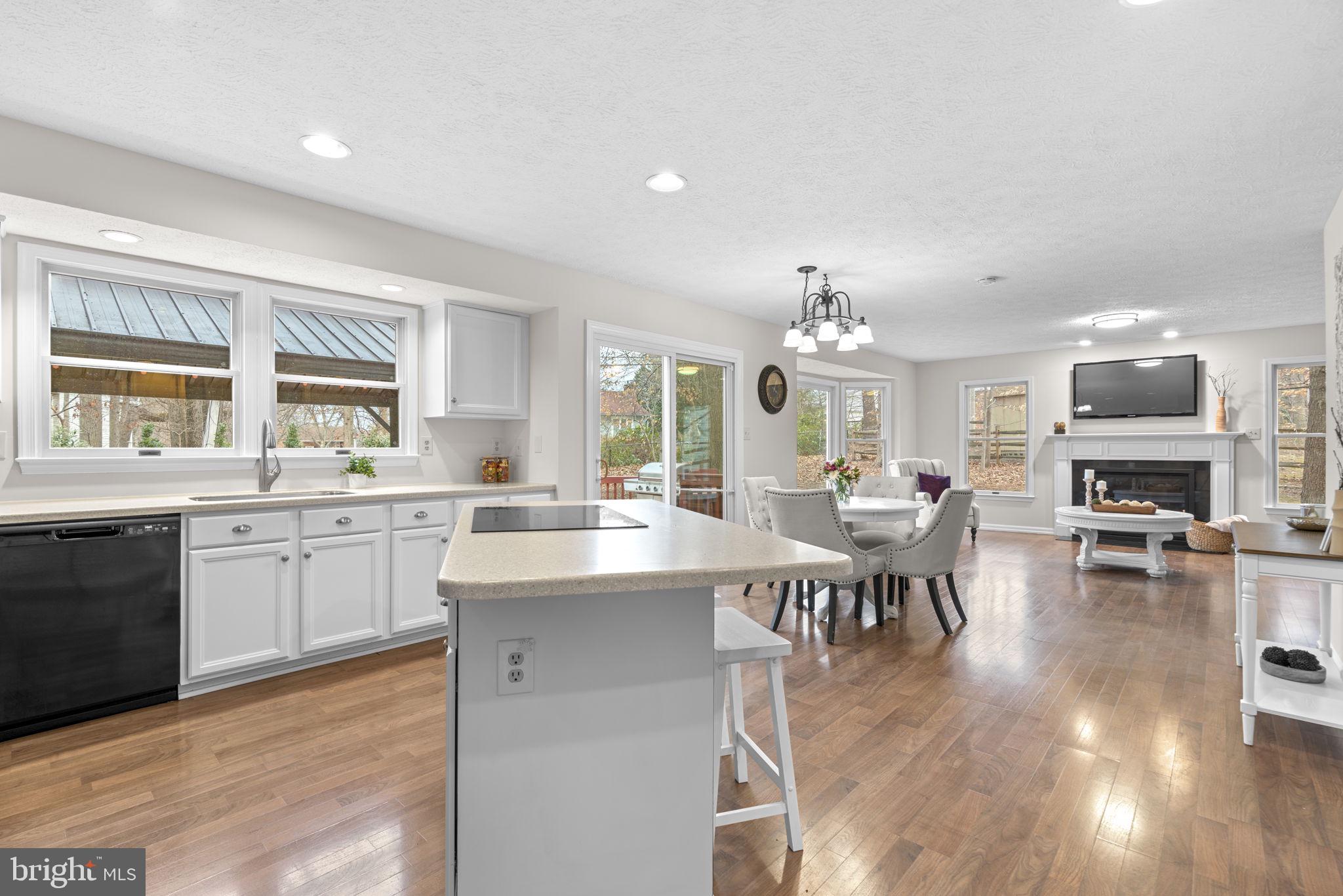 6241 Martin Road Columbia, MD 21044 - Photo 12 of 53 a large kitchen with kitchen island a sink table and chairs