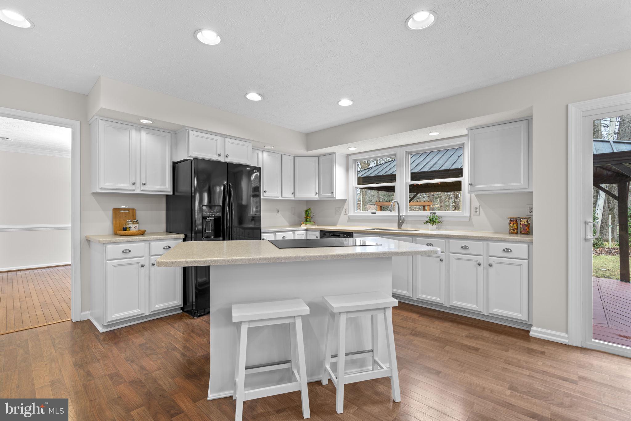 6241 Martin Road Columbia, MD 21044 - Photo 15 of 53 a kitchen with white cabinets and refrigerator