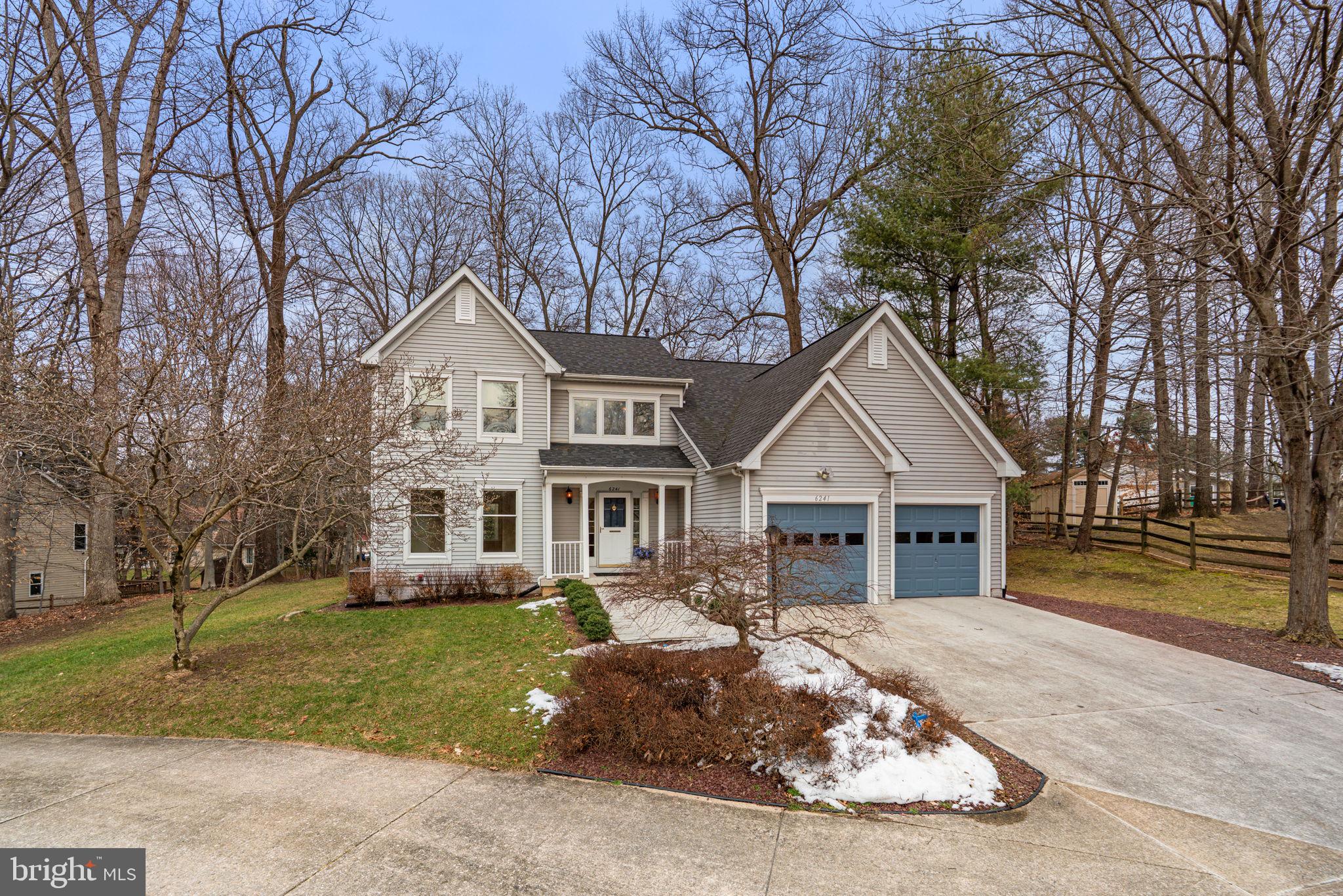 6241 Martin Road Columbia, MD 21044 - Photo 2 of 53 a front view of a house with a garden and trees