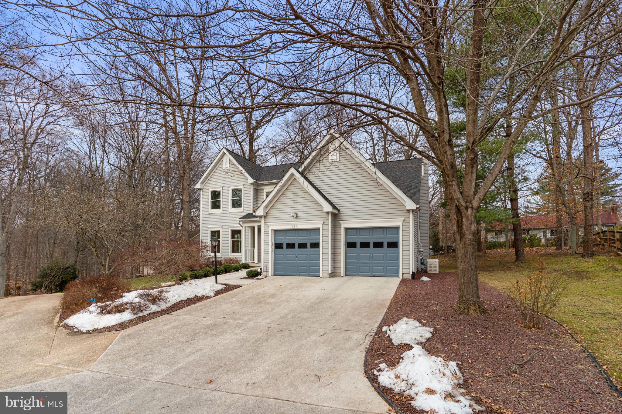 6241 Martin Road Columbia, MD 21044 - Photo 3 of 53 a view of a white house with a large tree and yard
