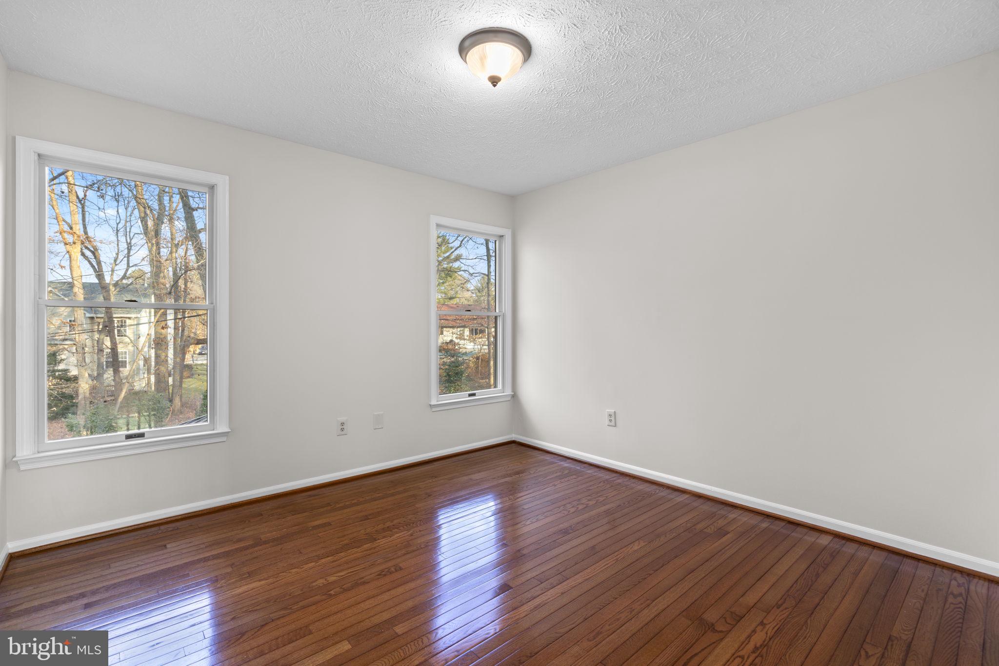 6241 Martin Road Columbia, MD 21044 - Photo 39 of 53 an empty room with wooden floor and windows