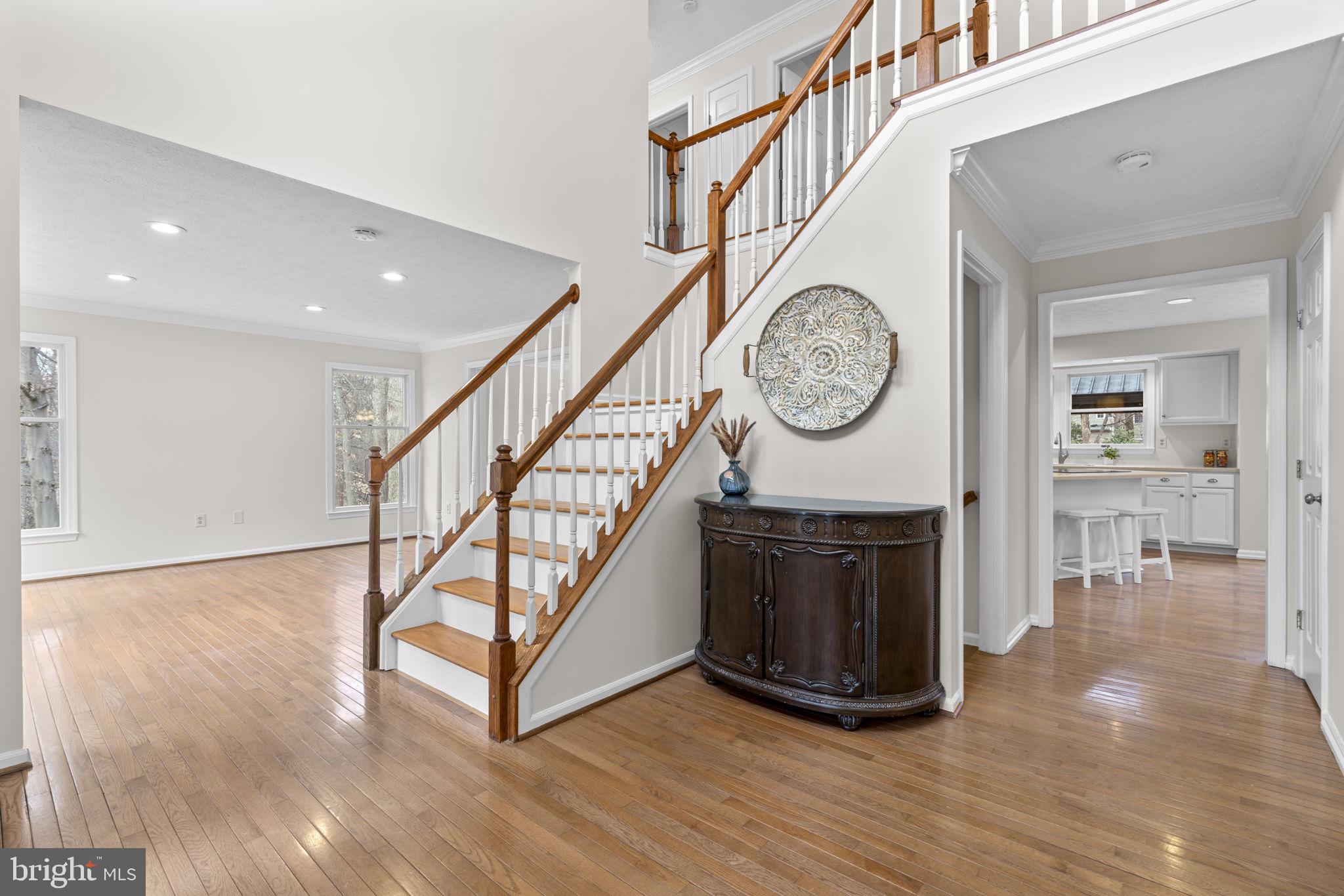 6241 Martin Road Columbia, MD 21044 - Photo 4 of 53 a view of a hallway with wooden floor and a clock on wall