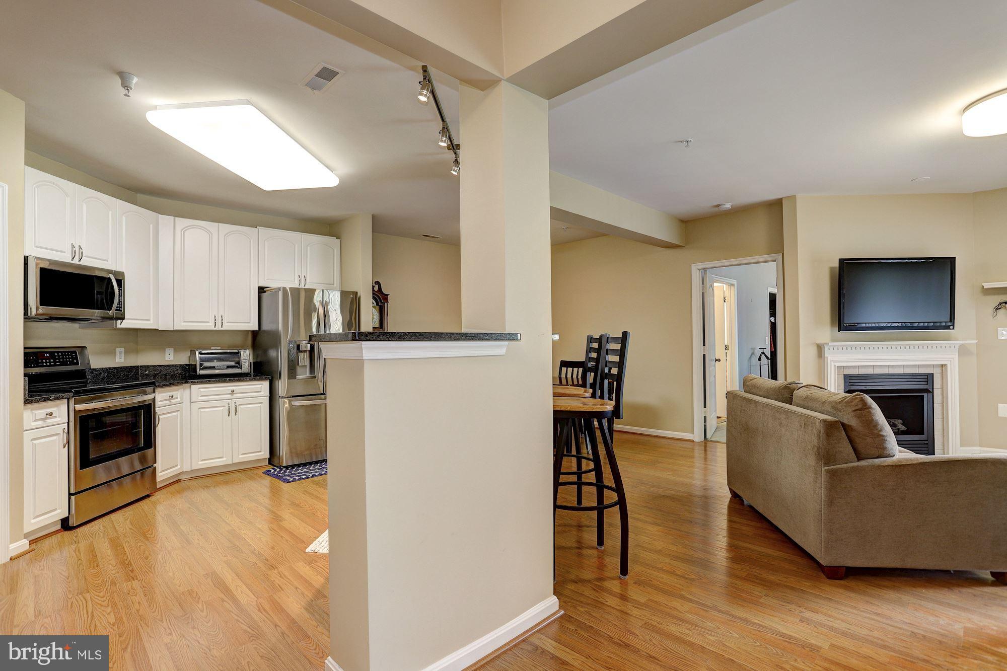 400 Symphony Circle, Unit 354D Cockeysville, MD 21030 - Photo 33 of 33 a living room with furniture and a flat screen tv