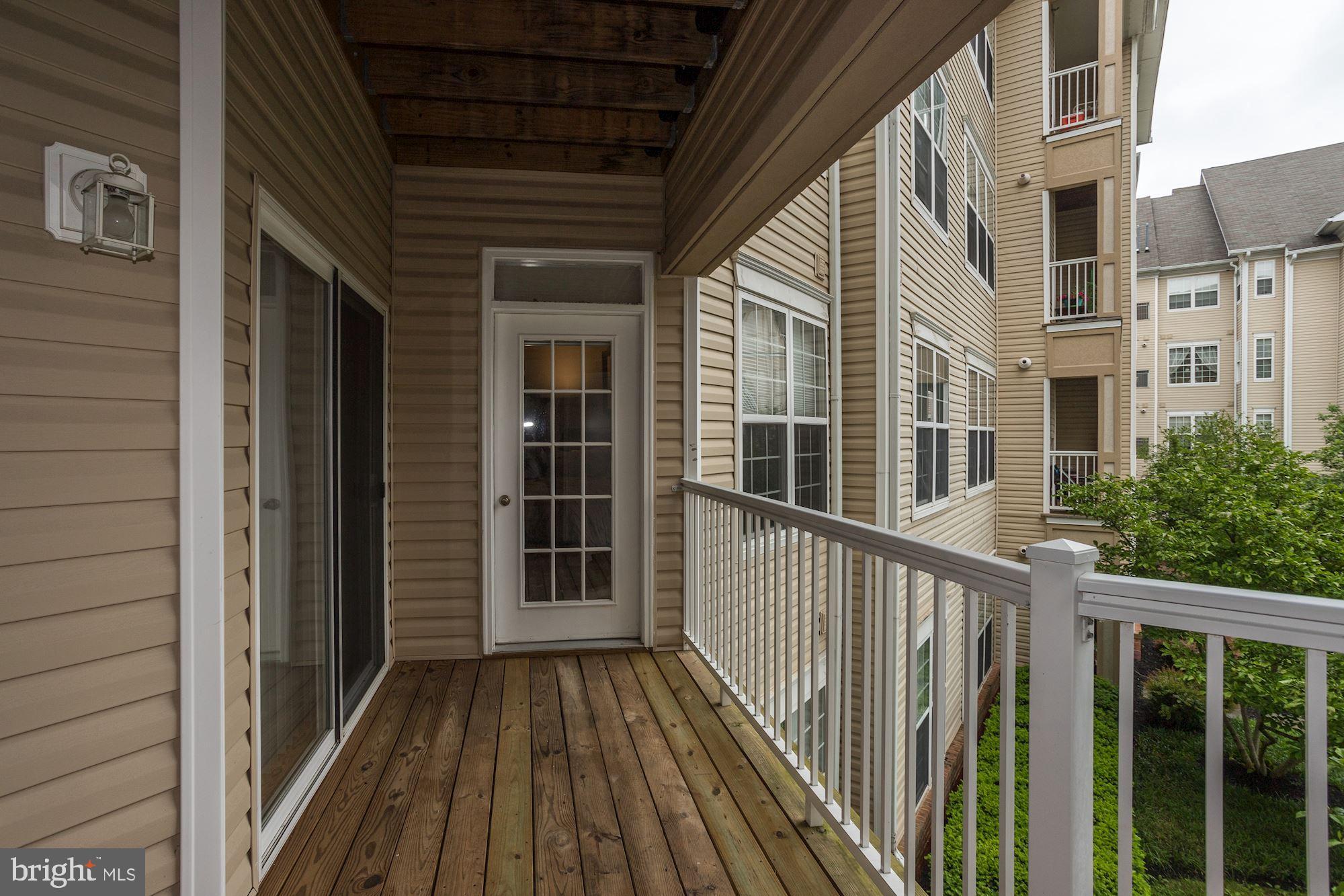 400 Symphony Circle, Unit 354D Cockeysville, MD 21030 - Photo 12 of 33 a view of a balcony with wooden floor