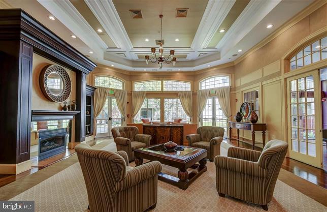 400 Symphony Circle, Unit 354D Cockeysville, MD 21030 - Photo 25 of 33 a living room with furniture a chandelier and a large window