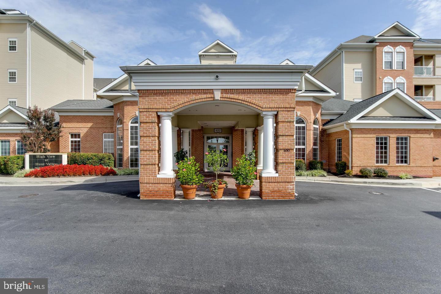 400 Symphony Circle, Unit 354D Cockeysville, MD 21030 - Photo 28 of 33 a view of a building with car parked