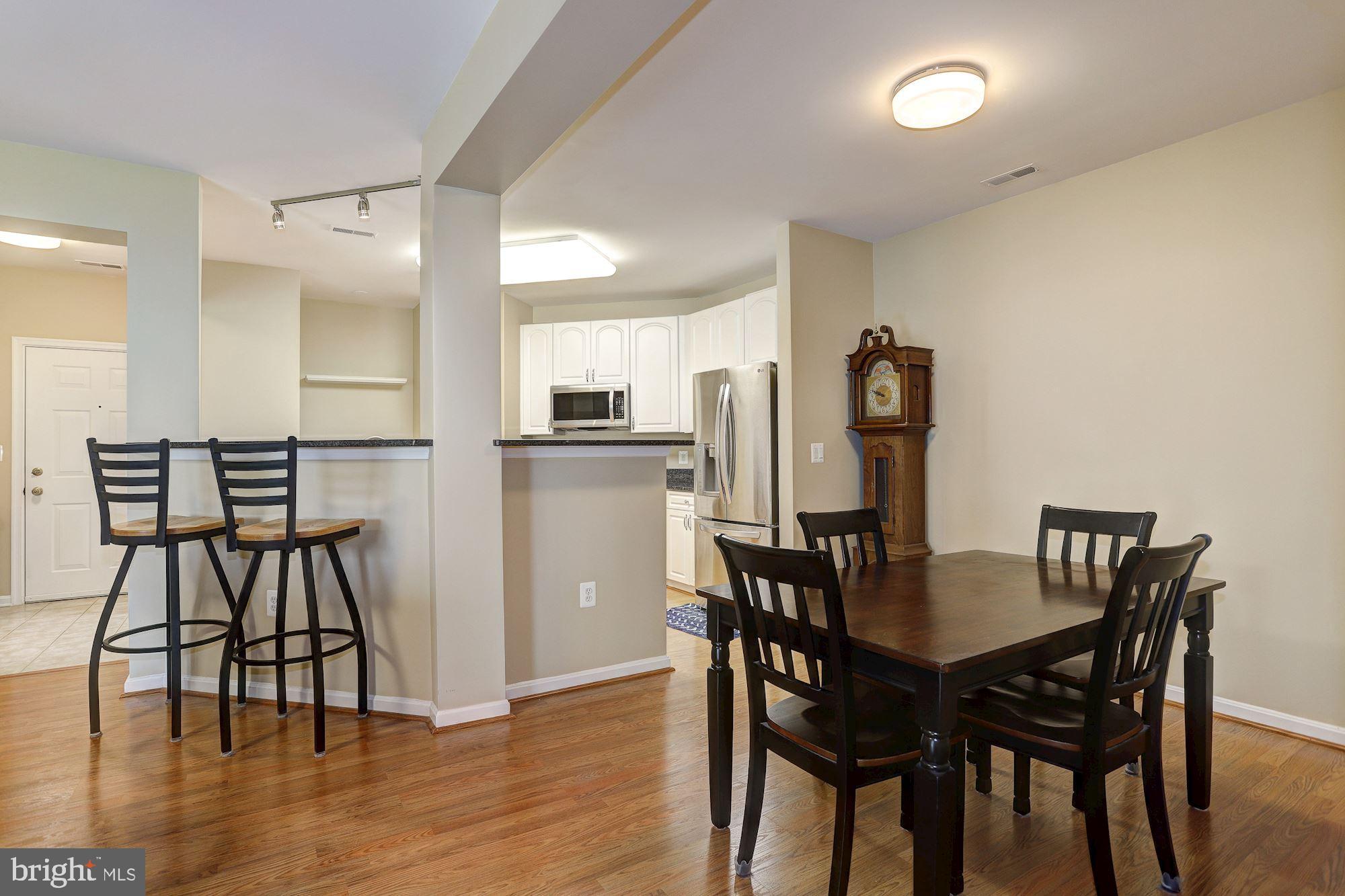 400 Symphony Circle, Unit 354D Cockeysville, MD 21030 - Photo 3 of 33 a view of a dining room with furniture and wooden floor
