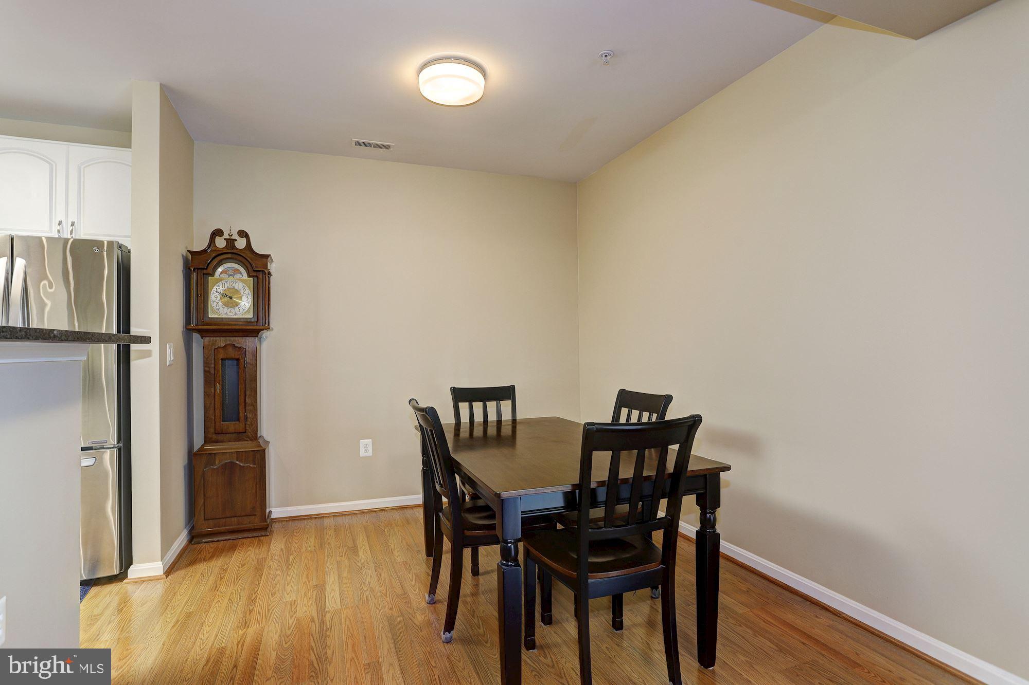 400 Symphony Circle, Unit 354D Cockeysville, MD 21030 - Photo 4 of 33 a view of a dining room with furniture and wooden floor
