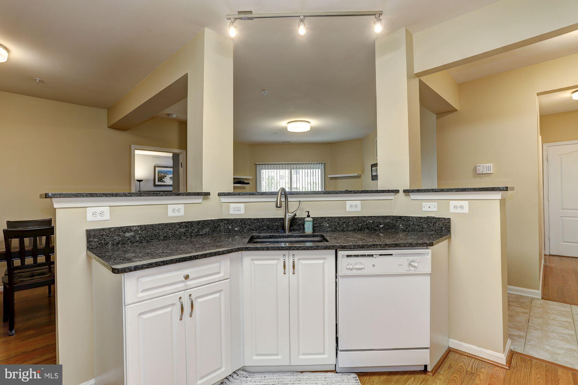 400 Symphony Circle, Unit 354D Cockeysville, MD 21030 - Photo 6 of 33 a sink with granite countertop a sink and cabinets