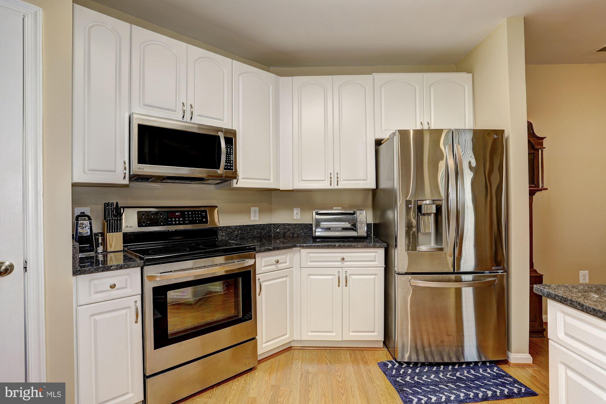 400 Symphony Circle, Unit 354D Cockeysville, MD 21030 - Photo 8 of 33 a kitchen with a refrigerator stove and microwave