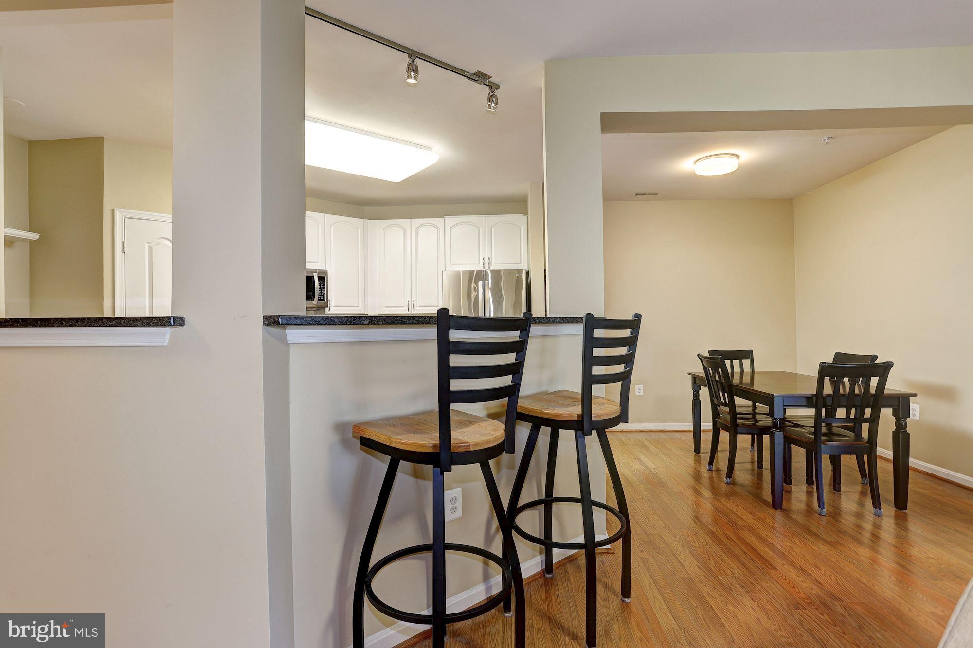 400 Symphony Circle, Unit 354D Cockeysville, MD 21030 - Photo 9 of 33 a view of a dining room with furniture and wooden floor