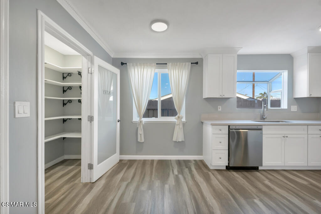 896 Moffatt Circle Simi Valley, CA 93065 - Photo 18 of 50 a kitchen with a refrigerator and white cabinets
