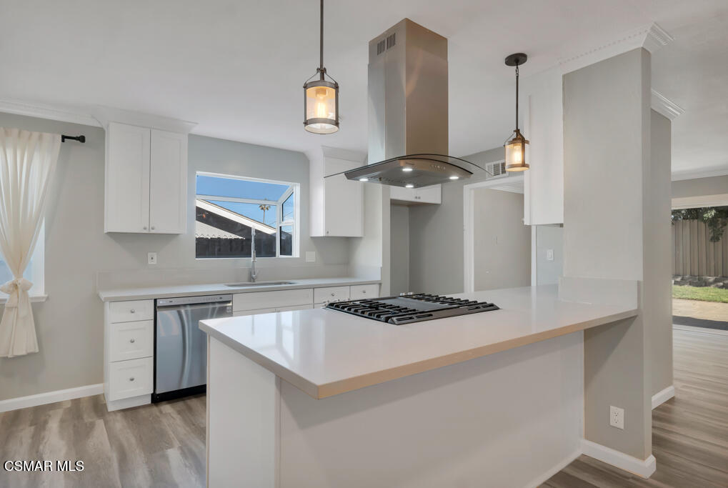 896 Moffatt Circle Simi Valley, CA 93065 - Photo 20 of 50 a kitchen with kitchen island stainless steel appliances a sink stove and white cabinets